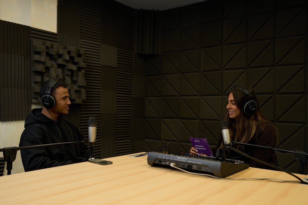 Students recording in the podcast studio
